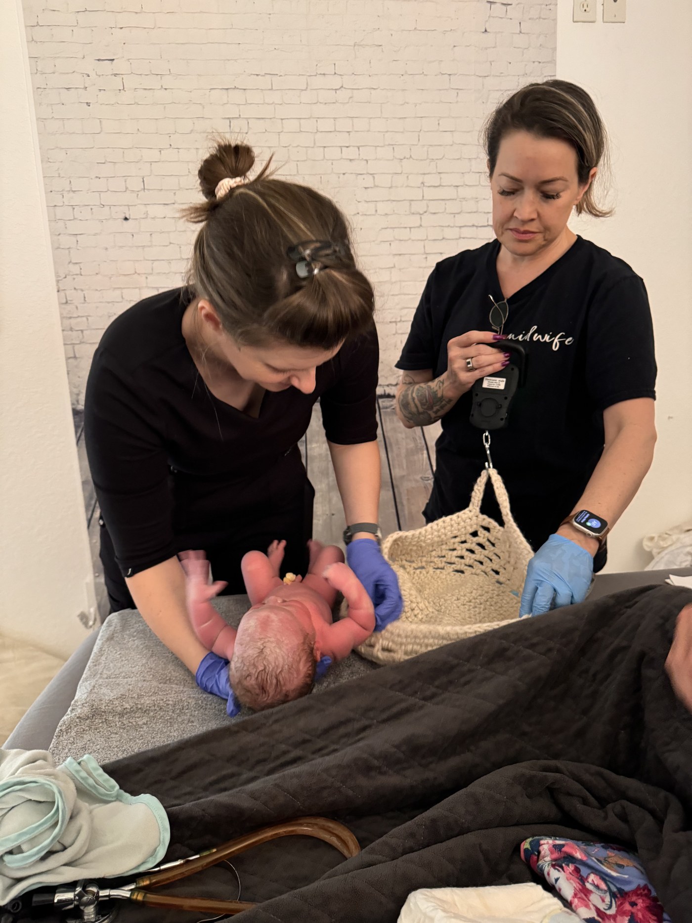 Midwives caring for a newborn at a Guardian Midwifery birth