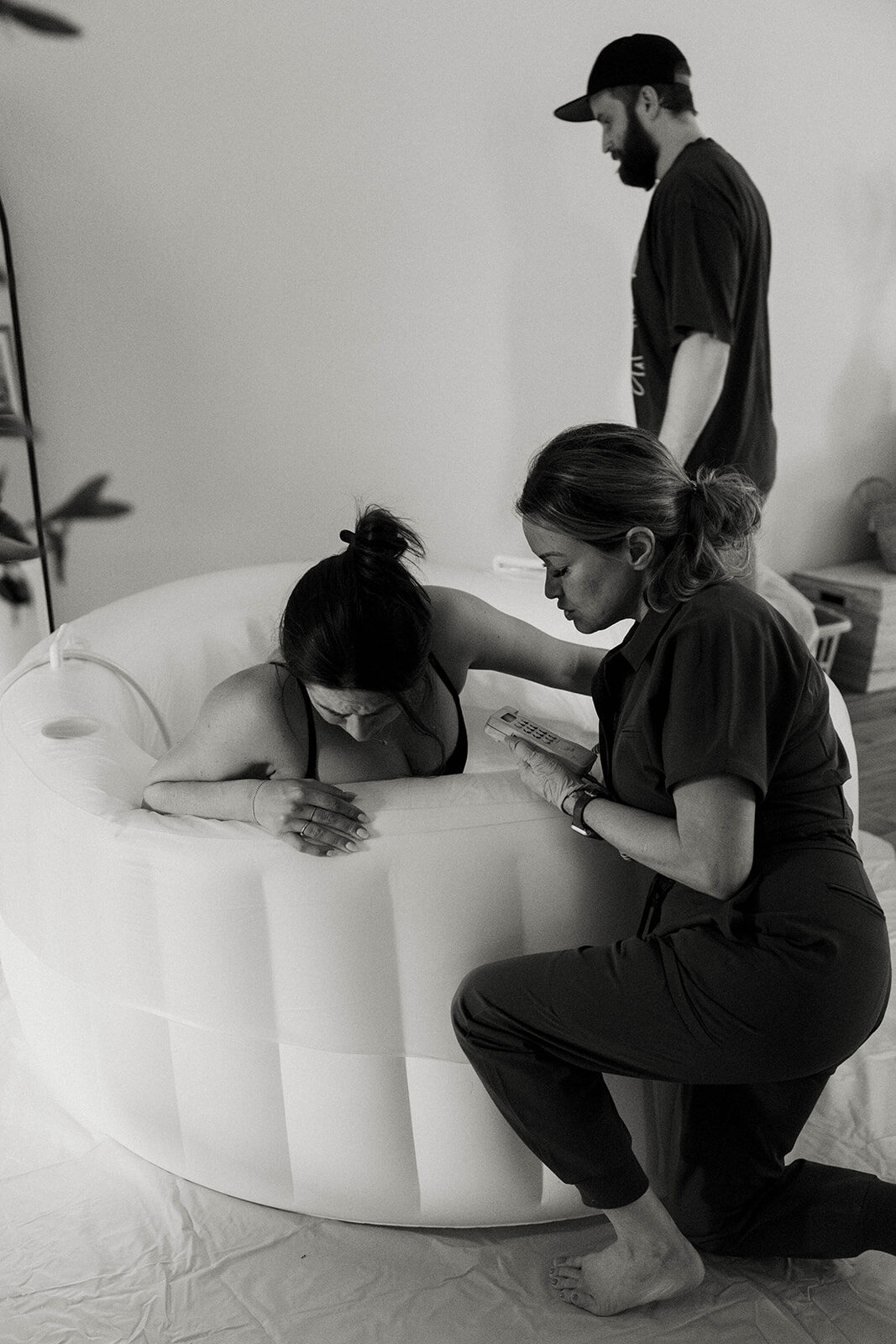 A partner and Rhonda supporting a mother in labor