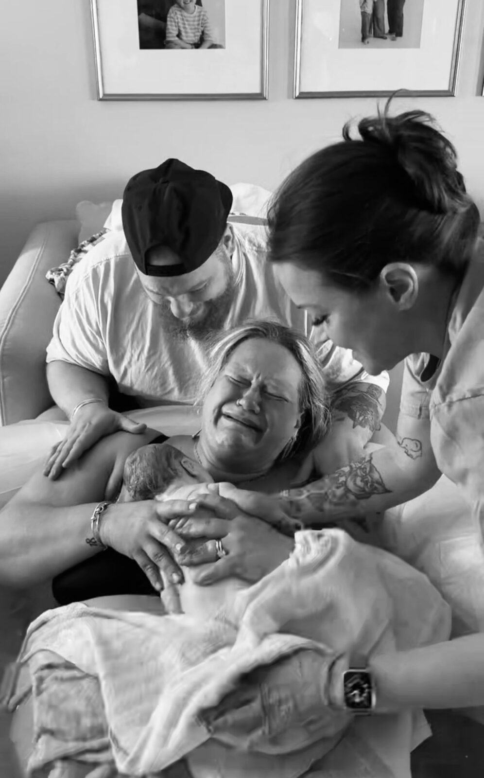 A family holding their newborn just after birth