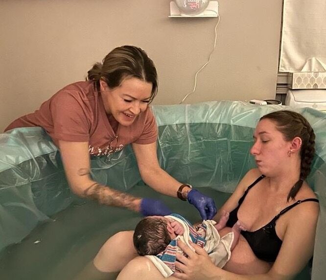 A mother nursing her newborn after a water birth